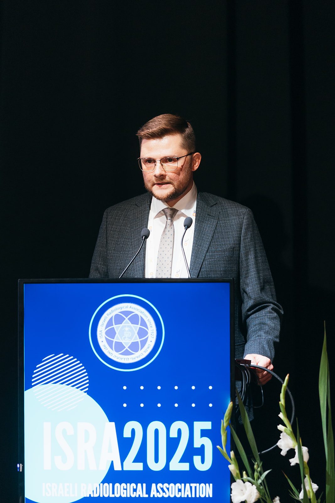 Dr Konstantin Kenigsberg speaking at ISRA 2025